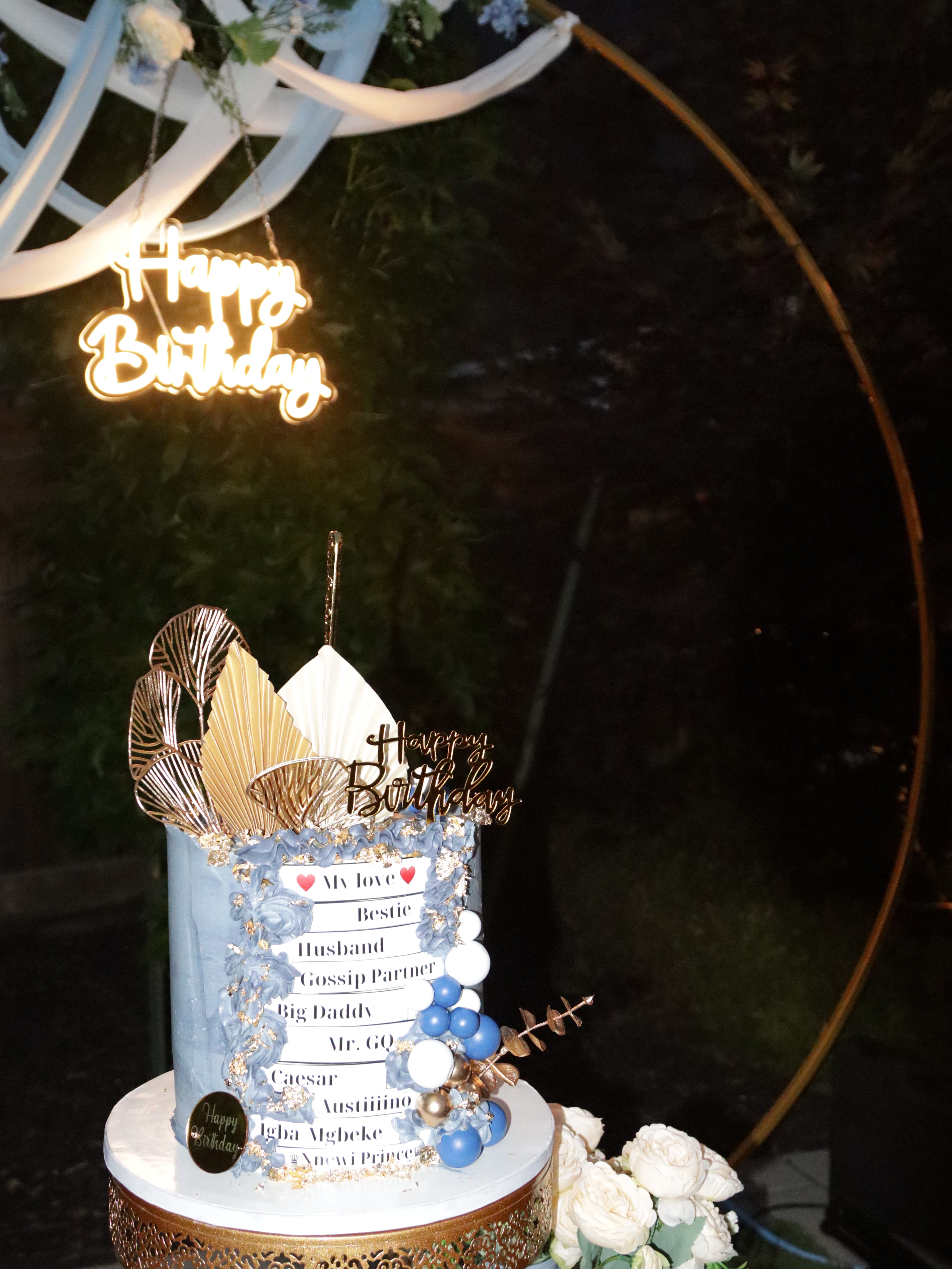 Close-up of a birthday cake with a glowing neon sign