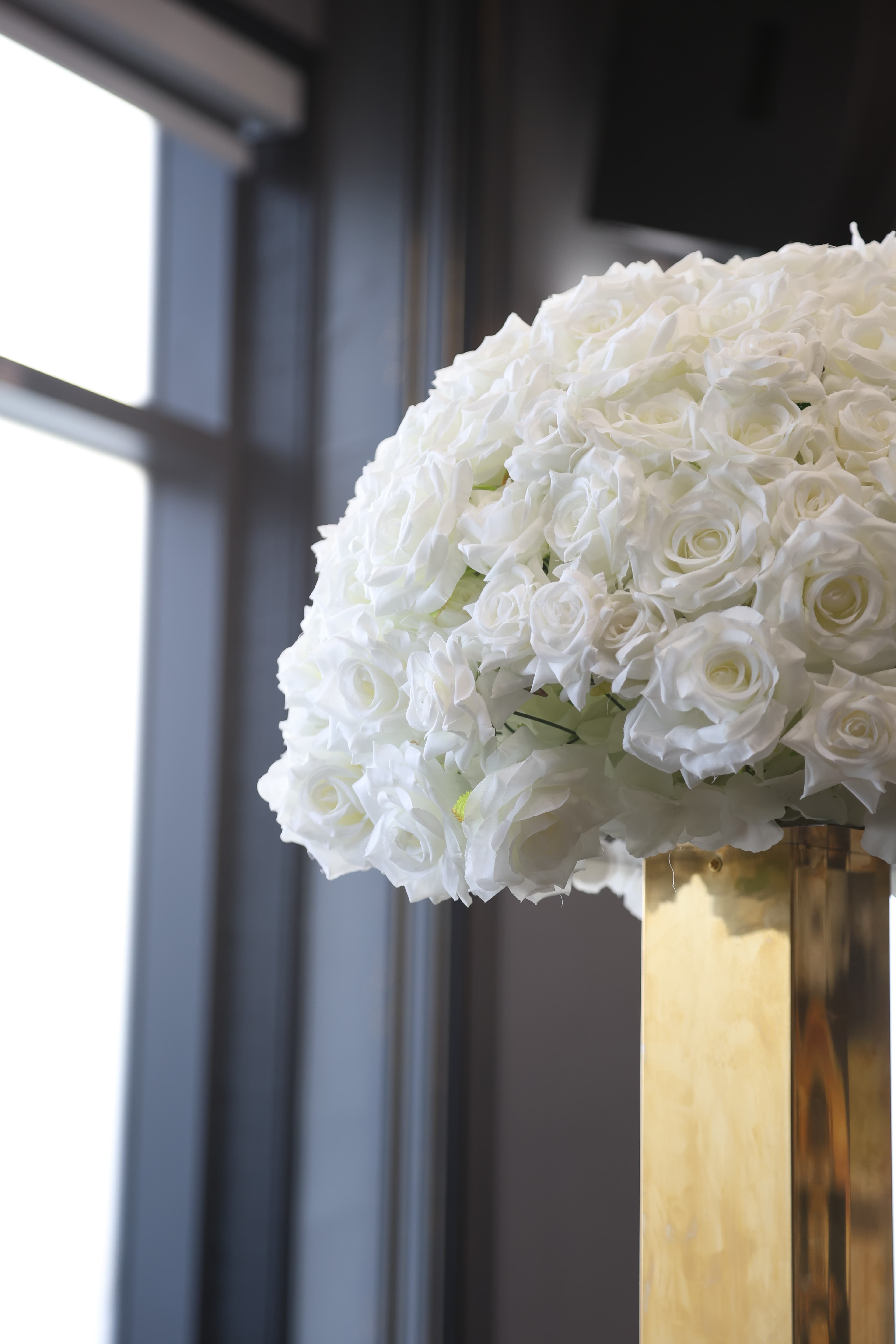 White rose bouquet on a gold stand